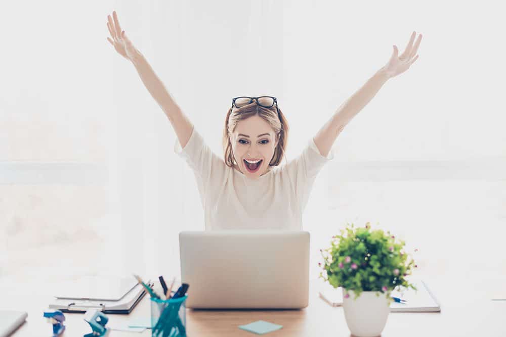excited lady on laptop